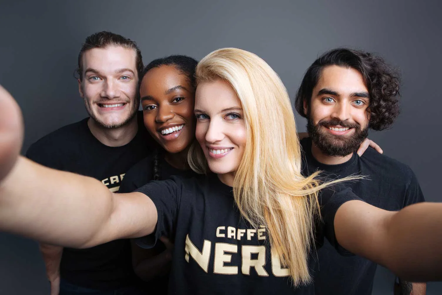 Four Caffè Nero team members taking a group selfie